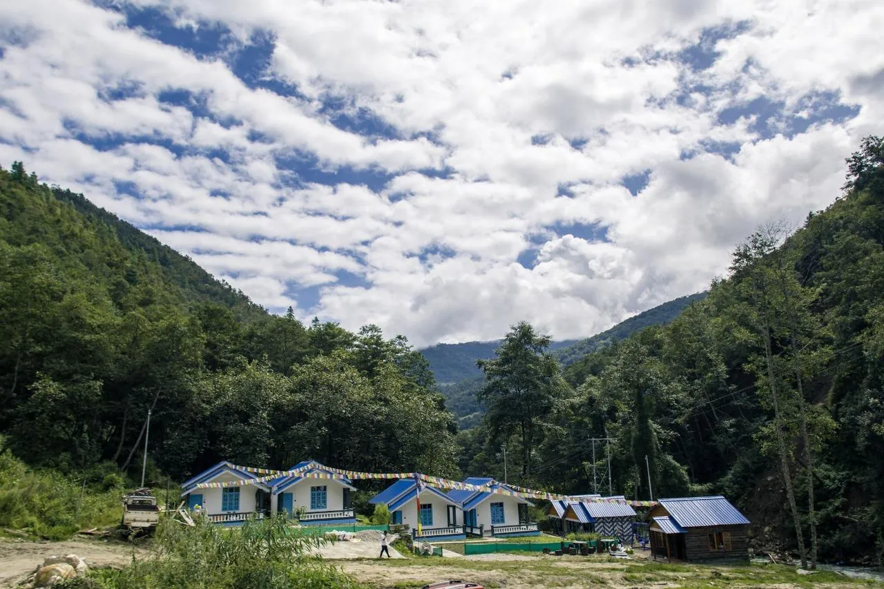 Cottage with dramatic cloudy mountain skies